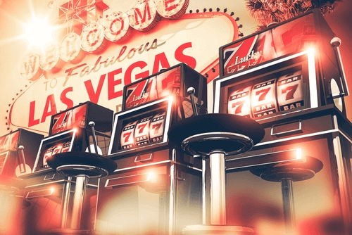 Best Casino Slots to Play - Illustration of Slots Machines in a Row in front of Vegas Sign